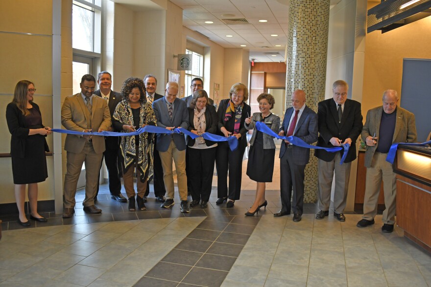 Cecelia Mason / Shepherd University officials cutting a ribbon to celebrate the expansion of the school's PBM facility